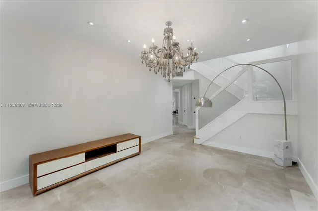 a view of room with stairs and a chandelier