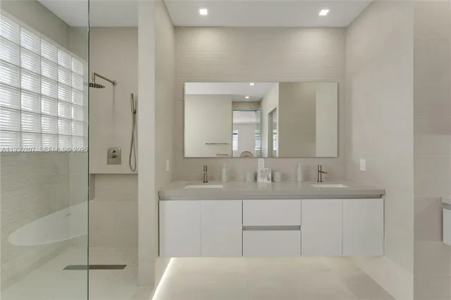 a bathroom with a double vanity sink and mirror