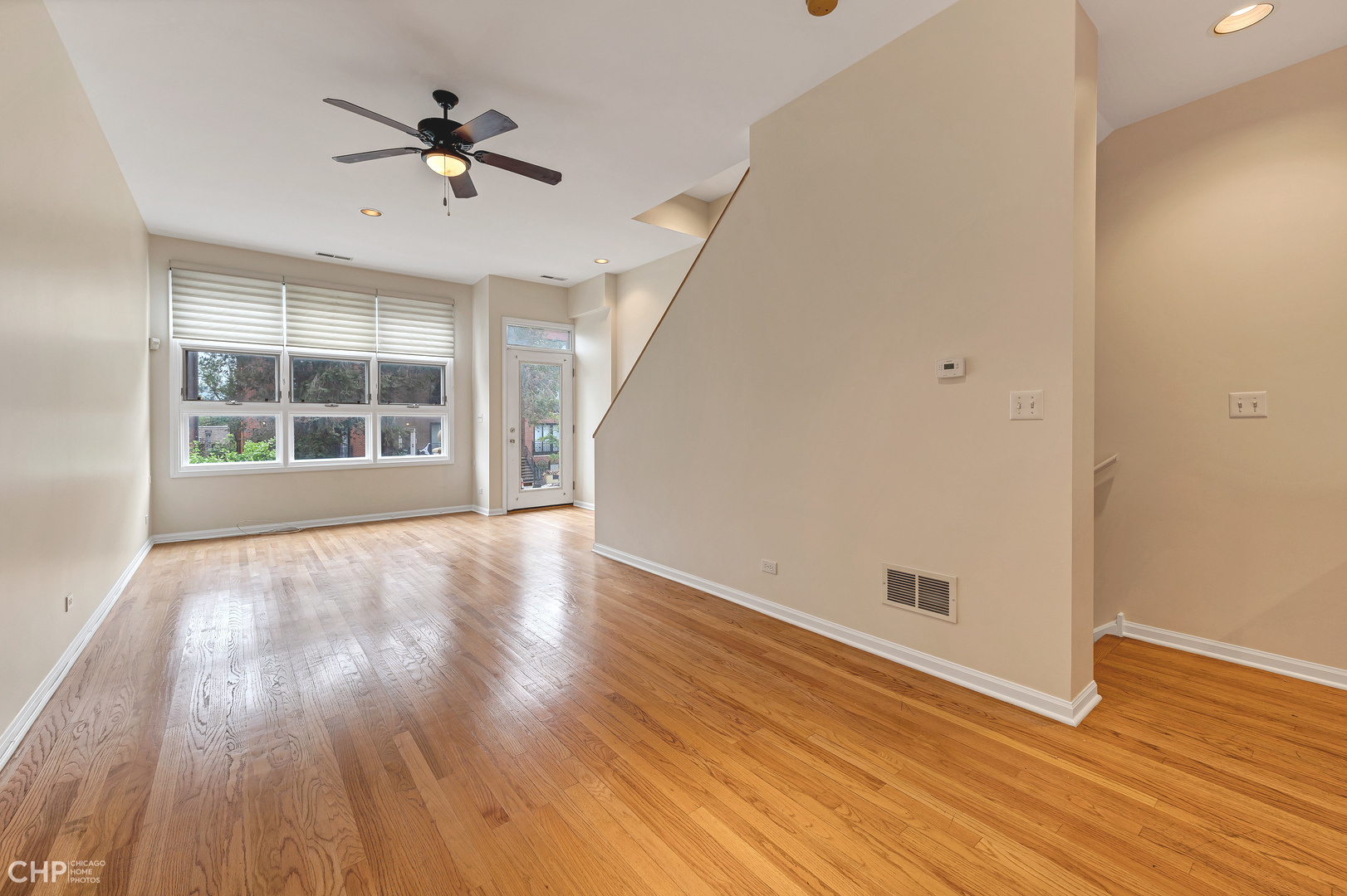 855 West Erie Street, Unit 126 Chicago, IL 60642 - Photo 2 of 24 an empty room with wooden floor and windows