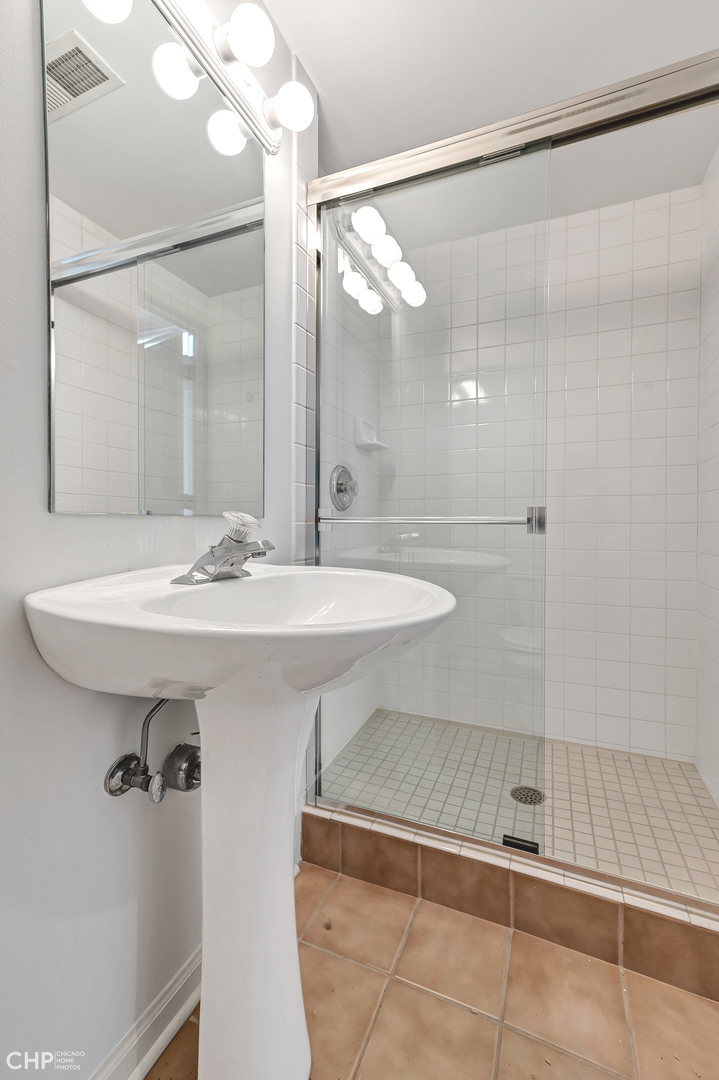 855 West Erie Street, Unit 126 Chicago, IL 60642 - Photo 14 of 24 a bathroom with a sink and mirror