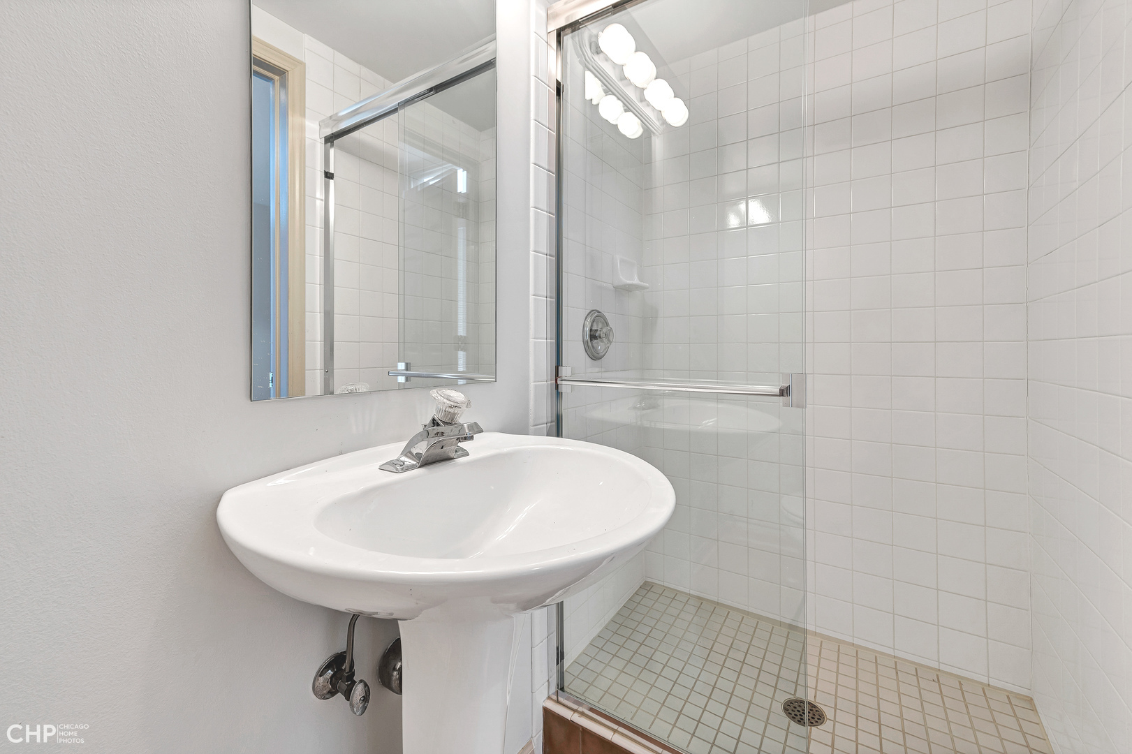855 West Erie Street, Unit 126 Chicago, IL 60642 - Photo 15 of 24 a bathroom with a sink a shower and a mirror