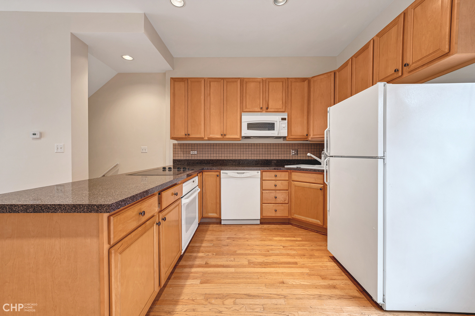 855 West Erie Street, Unit 126 Chicago, IL 60642 - Photo 4 of 24 a kitchen with stainless steel appliances granite countertop a refrigerator sink and cabinets