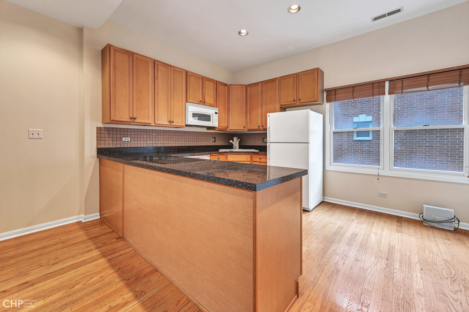 855 West Erie Street, Unit 126 Chicago, IL 60642 - Photo 5 of 24 a kitchen with stainless steel appliances granite countertop a refrigerator a stove a sink and a microwave
