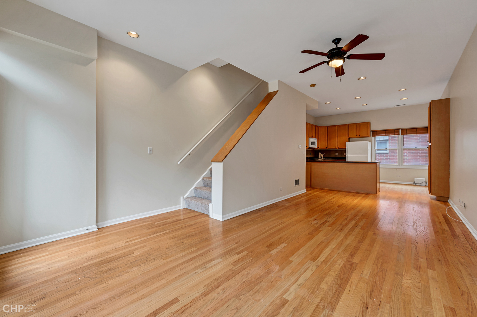 855 West Erie Street, Unit 126 Chicago, IL 60642 - Photo 6 of 24 a view of a livingroom with wooden floor and a ceiling fan