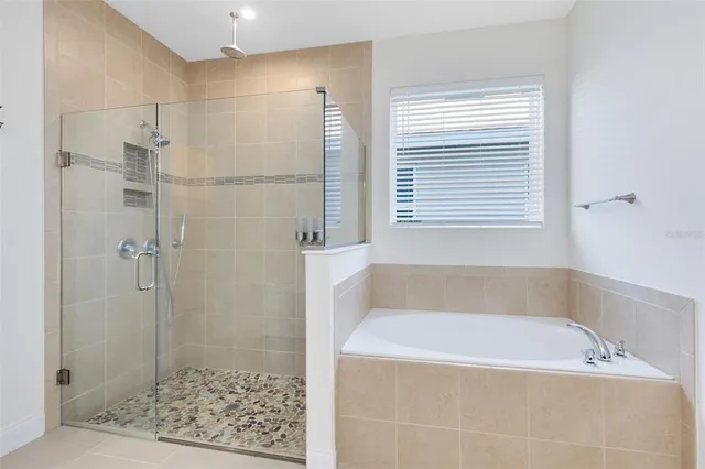 a bathroom with a bathtub and shower