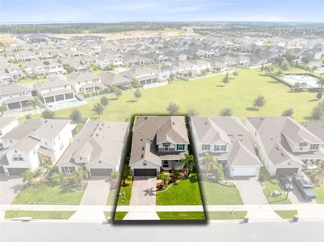an aerial view of residential houses with outdoor space