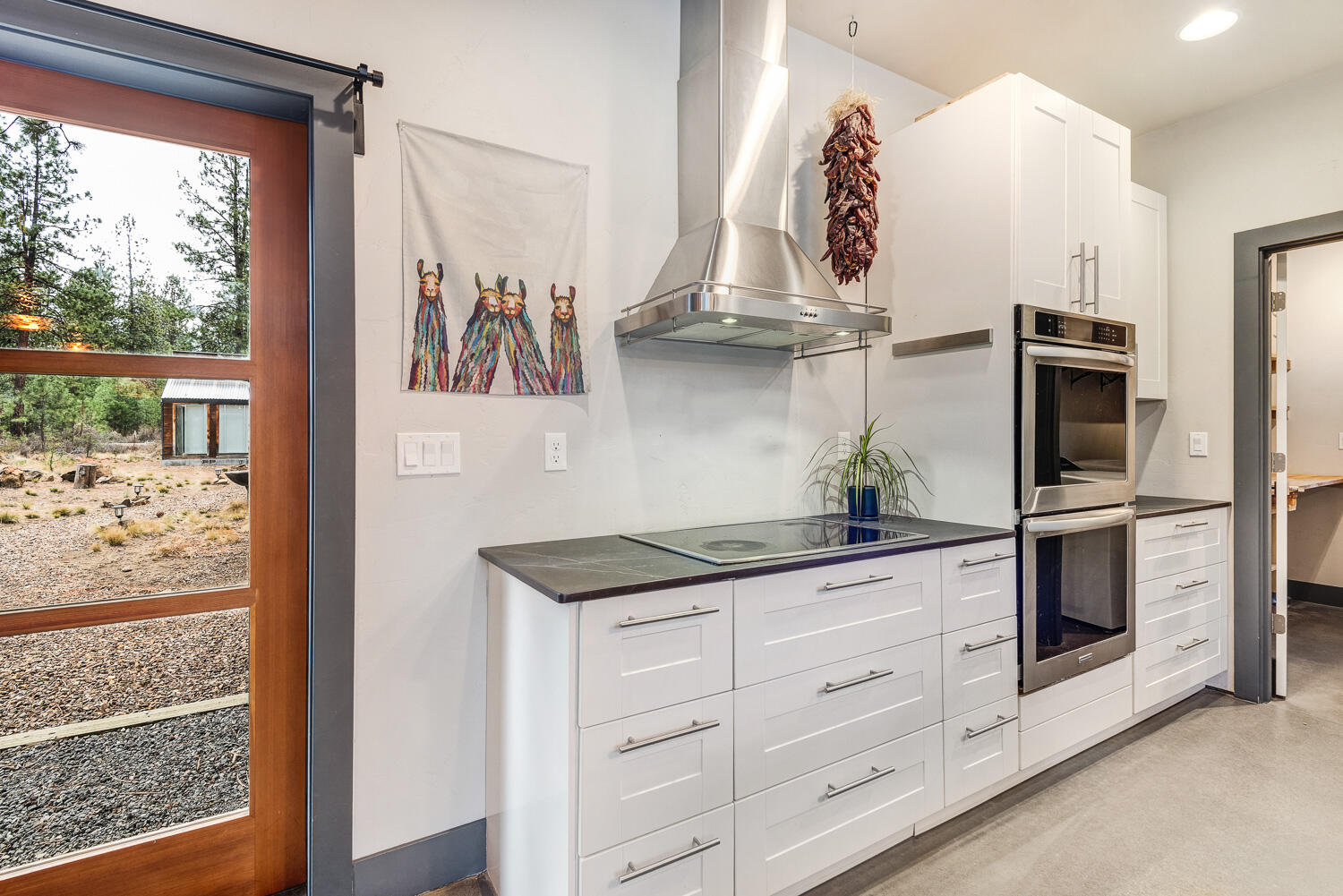 19354 Kiowa Road Bend, OR 97702 - Photo 16 of 37 a kitchen with stainless steel appliances cabinets and a large window