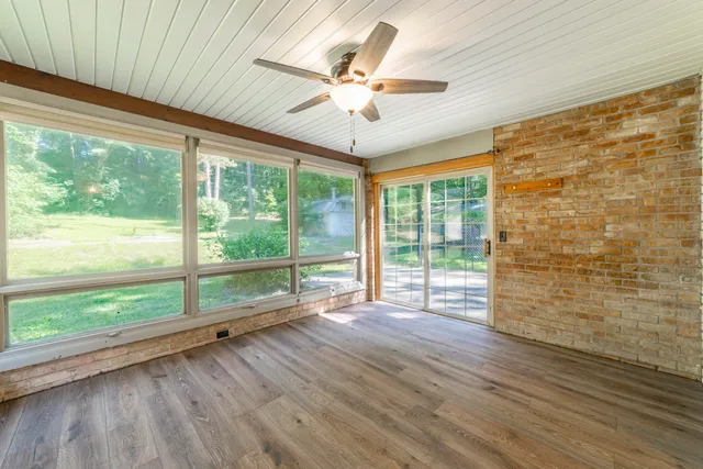 a bathroom with a toilet a sink and a window
