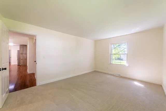 a view of a big room with closet and windows