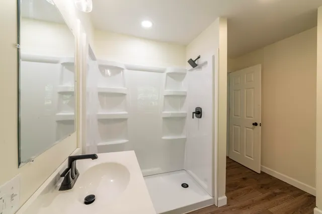 a front view of a house with a yard and trees