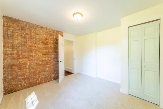 a view of a house with a yard and a large tree
