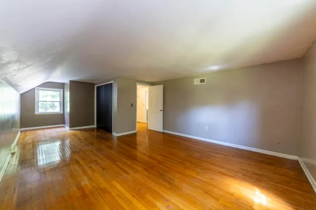 a view of backyard of house with green space