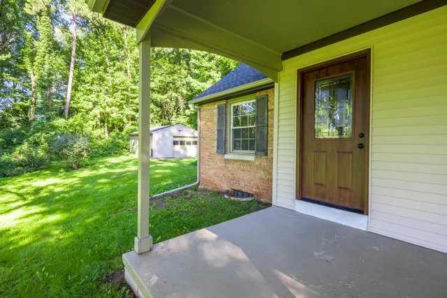 a view of a livingroom with wooden floor and a kitchen