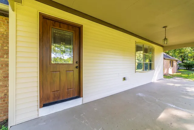 a kitchen with kitchen island a large counter top space wooden floor and stainless steel appliances