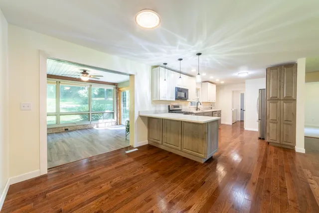 a kitchen with a sink a counter top space stainless steel appliances and cabinets