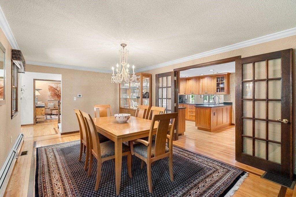 7 Ridge Hill Way Andover, MA 01810 - Photo 18 of 42 a view of a dining room with furniture a chandelier and wooden floor