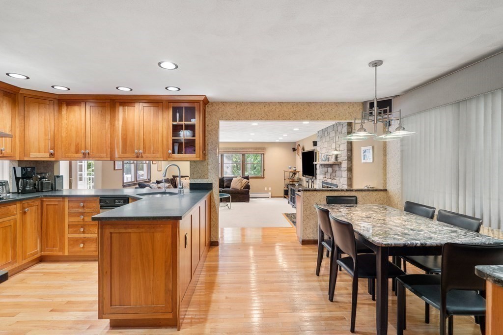 7 Ridge Hill Way Andover, MA 01810 - Photo 19 of 42 a kitchen with granite countertop kitchen island stainless steel appliances a dining table and chairs