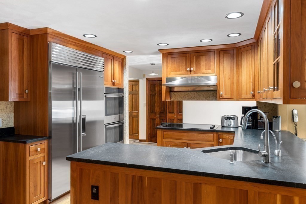 7 Ridge Hill Way Andover, MA 01810 - Photo 20 of 42 a kitchen with stainless steel appliances granite countertop a sink and a refrigerator