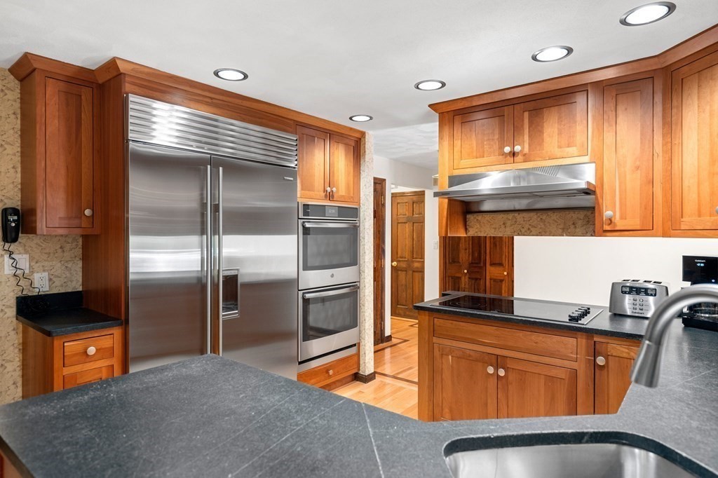7 Ridge Hill Way Andover, MA 01810 - Photo 21 of 42 a kitchen with stainless steel appliances granite countertop a refrigerator and a sink