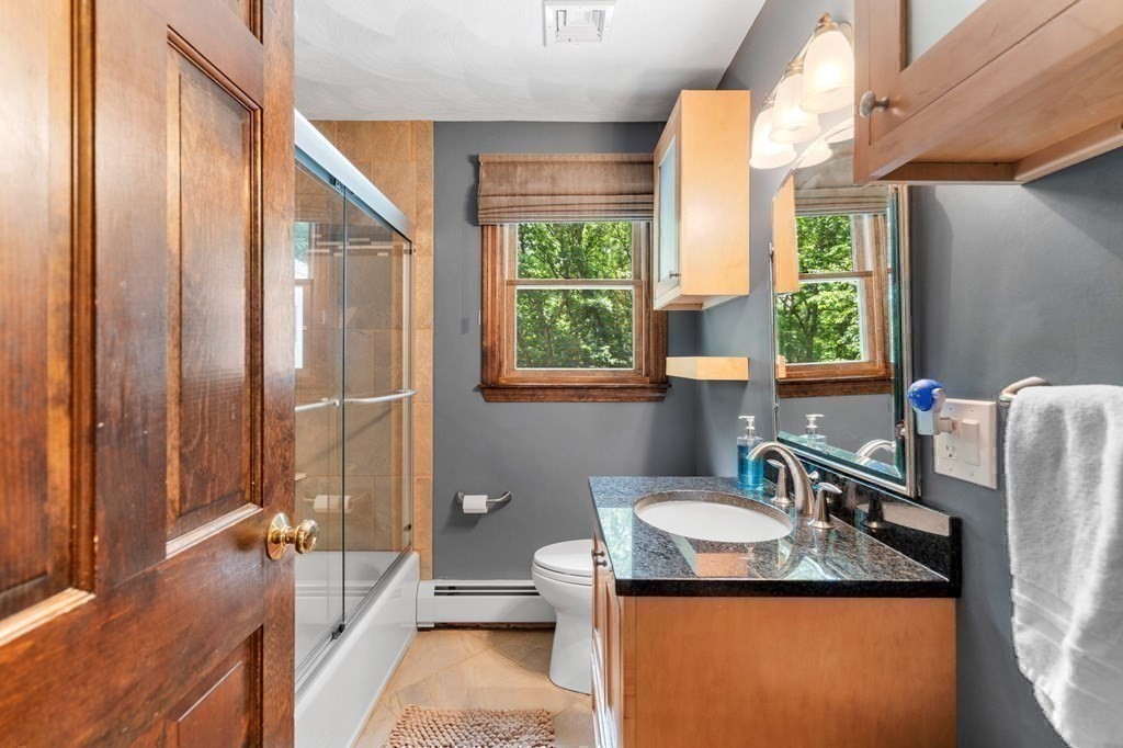 7 Ridge Hill Way Andover, MA 01810 - Photo 31 of 42 a bathroom with a granite countertop sink a mirror and a bathtub