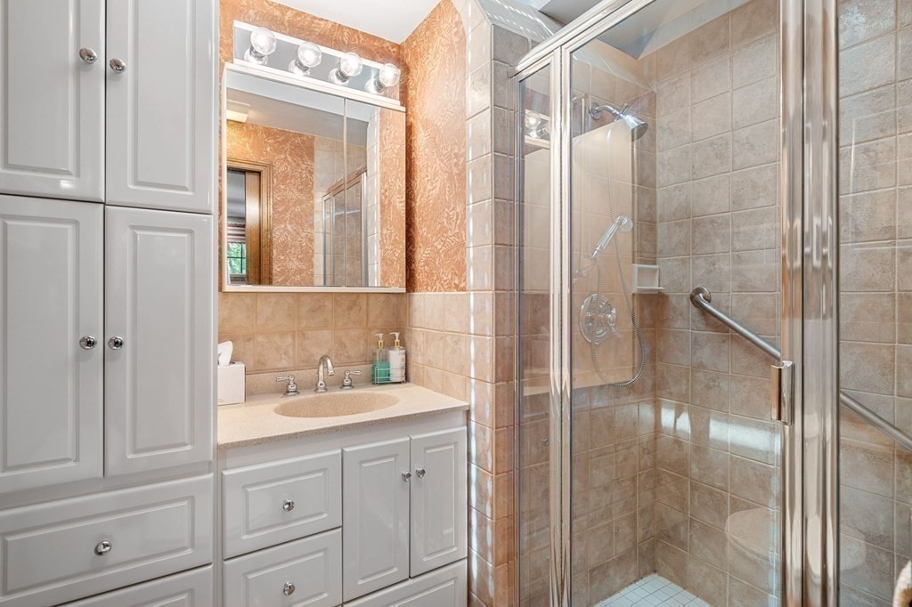 7 Ridge Hill Way Andover, MA 01810 - Photo 35 of 42 a bathroom with a shower sink and mirror