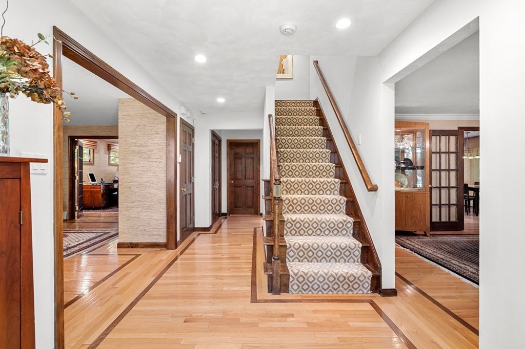 7 Ridge Hill Way Andover, MA 01810 - Photo 9 of 42 a view of a hallway with wooden floor and staircase
