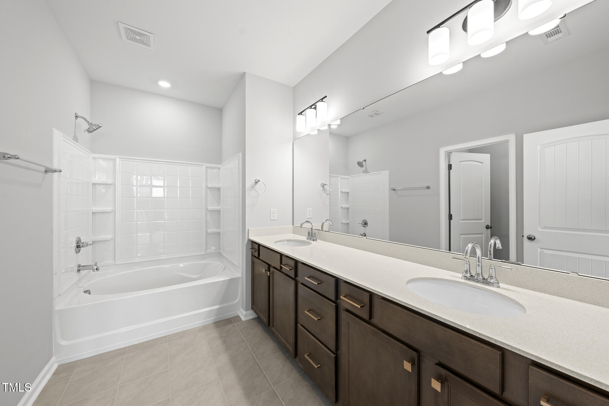 92 Ripple Way, Unit 315 Clayton, NC 27520 - Photo 10 of 42 Primary Bath with dual vanity topped with Quartz, tile floor and separate water closet