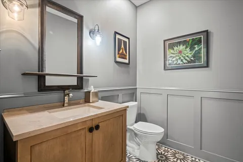 a bathroom with a toilet a sink and mirror