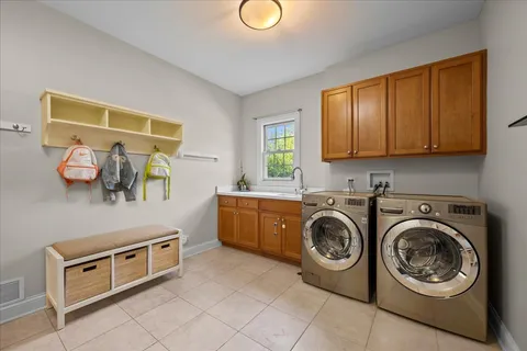 a utility room with sink dryer and washer