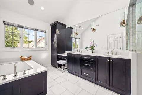 a spacious bathroom with a double vanity sink mirror and