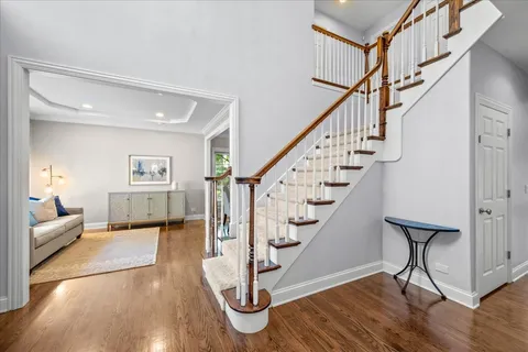 a view of entryway and hall with wooden floor
