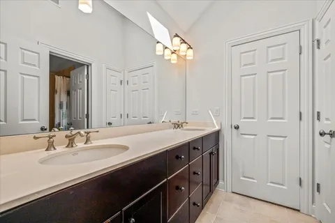 a bathroom with a double vanity sink and a mirror