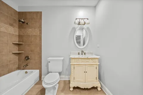 a bathroom with a granite countertop toilet a sink and a bathtub