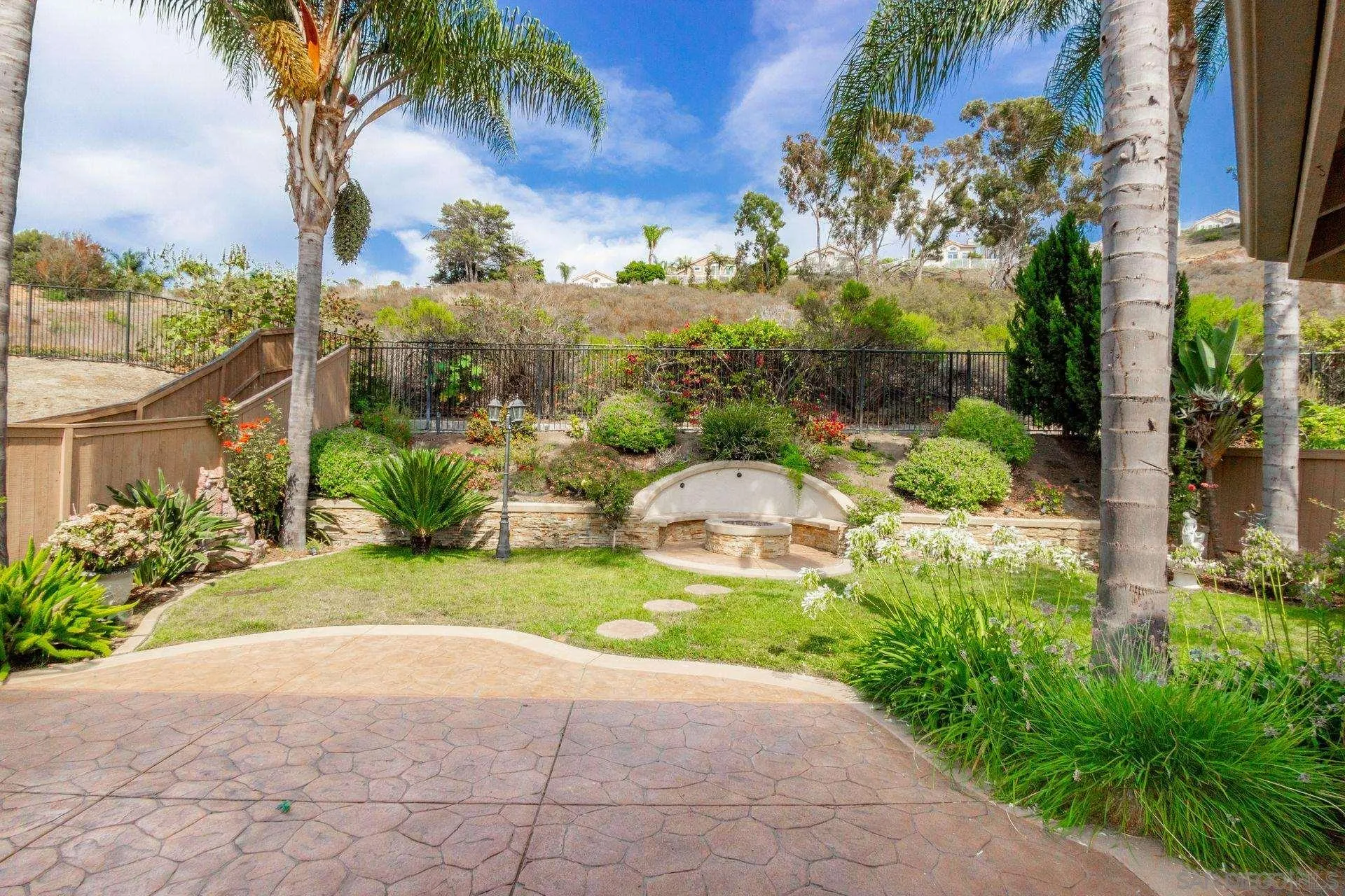 302 La Soledad Way Oceanside, CA 92057 - Photo 12 of 37 a view of a garden with a building in the background