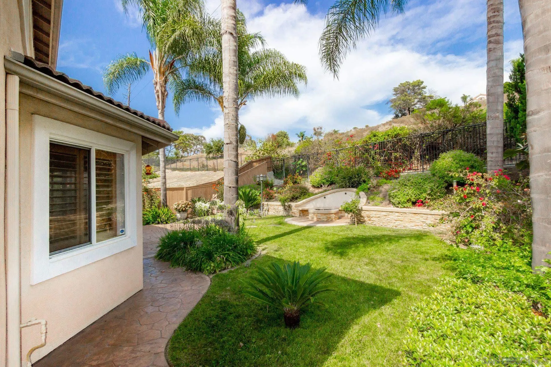 302 La Soledad Way Oceanside, CA 92057 - Photo 14 of 37 a view of a house with a yard and a garden
