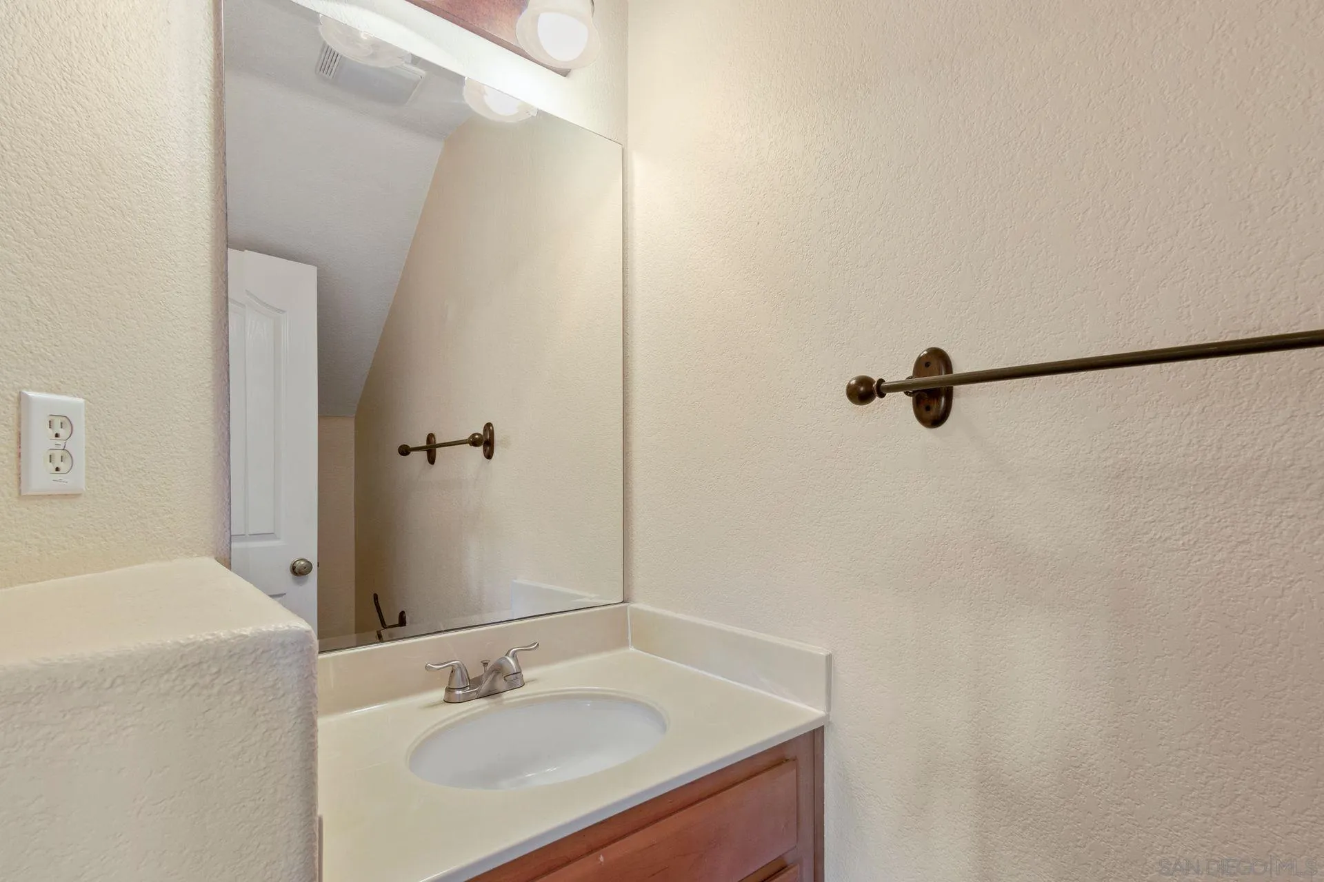 302 La Soledad Way Oceanside, CA 92057 - Photo 18 of 37 a bathroom with a sink and a mirror