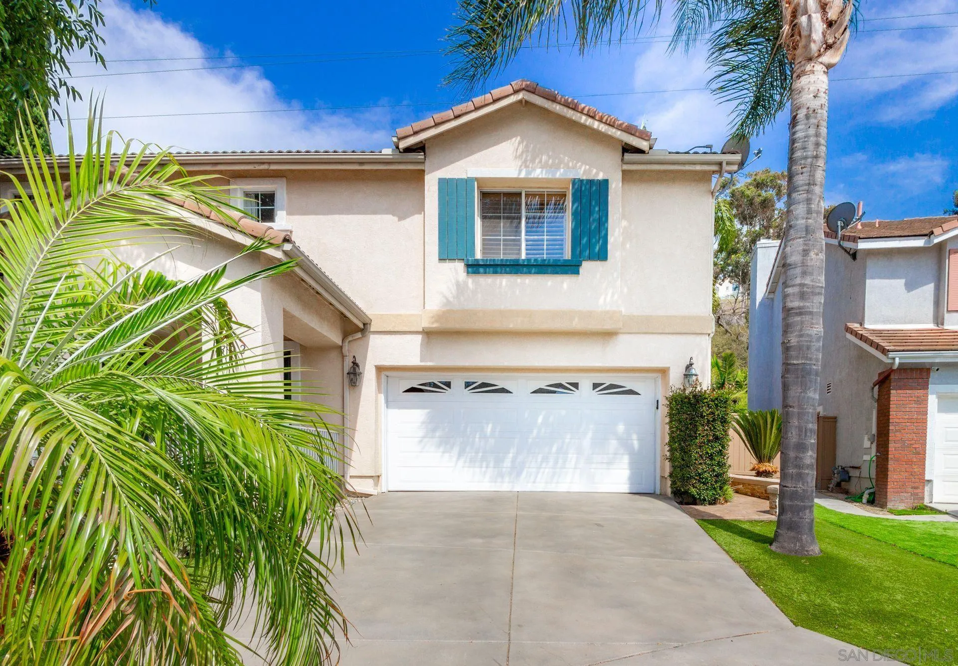 302 La Soledad Way Oceanside, CA 92057 - Photo 5 of 37 a front view of a house with a yard and garage