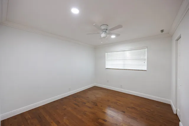 a view of hallway with stainless steel appliances granite countertop furniture and a large window