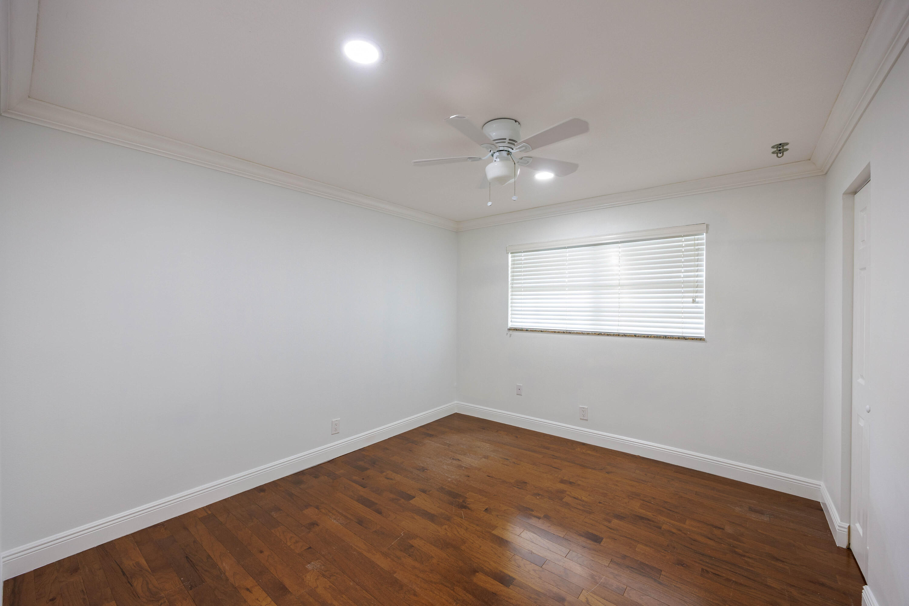 3001 Linton Boulevard, Unit 213C Delray Beach, FL 33445 - Photo 23 of 35 a view of empty room with wooden floor and fan