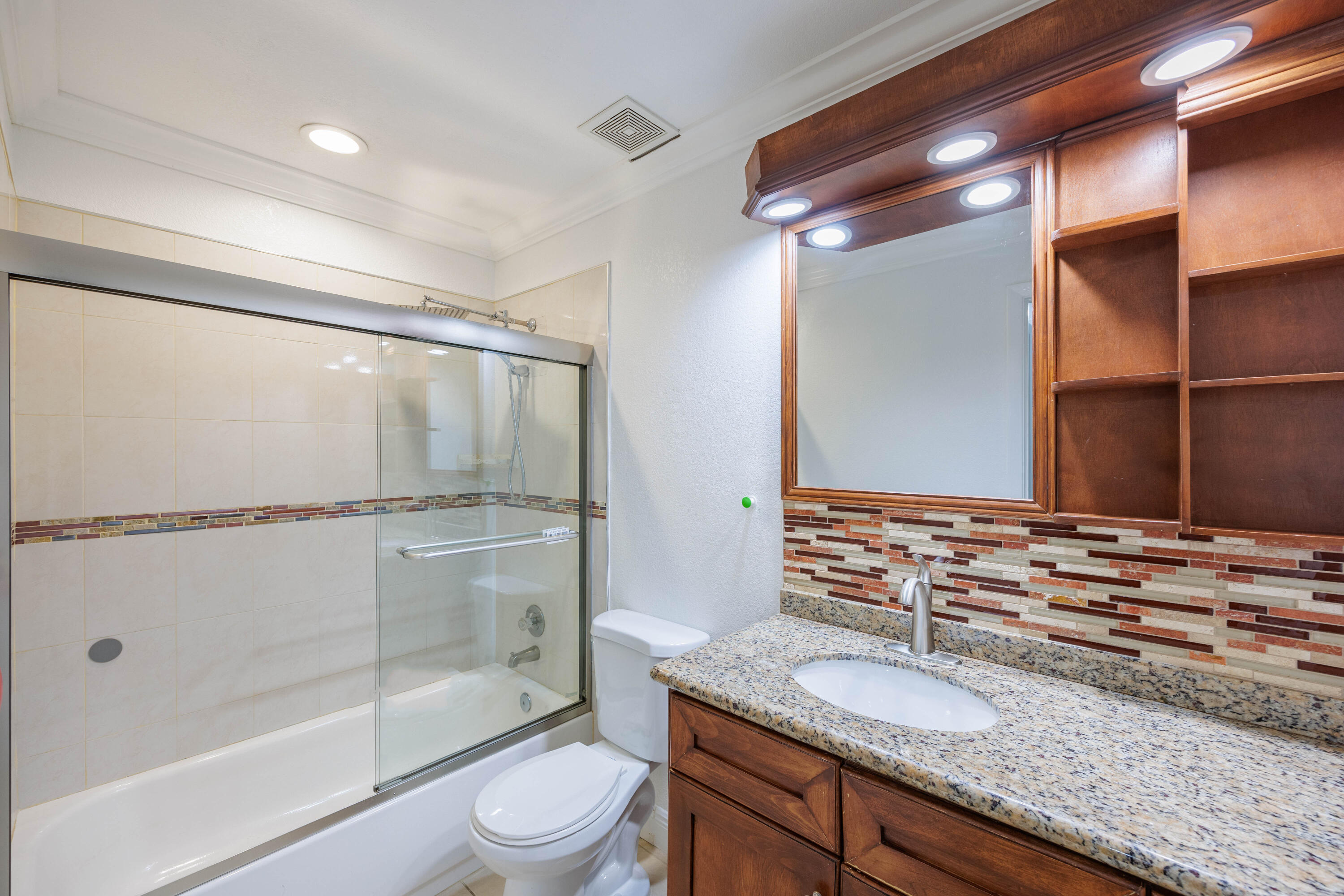 3001 Linton Boulevard, Unit 213C Delray Beach, FL 33445 - Photo 27 of 35 a bathroom with a granite countertop sink toilet and shower