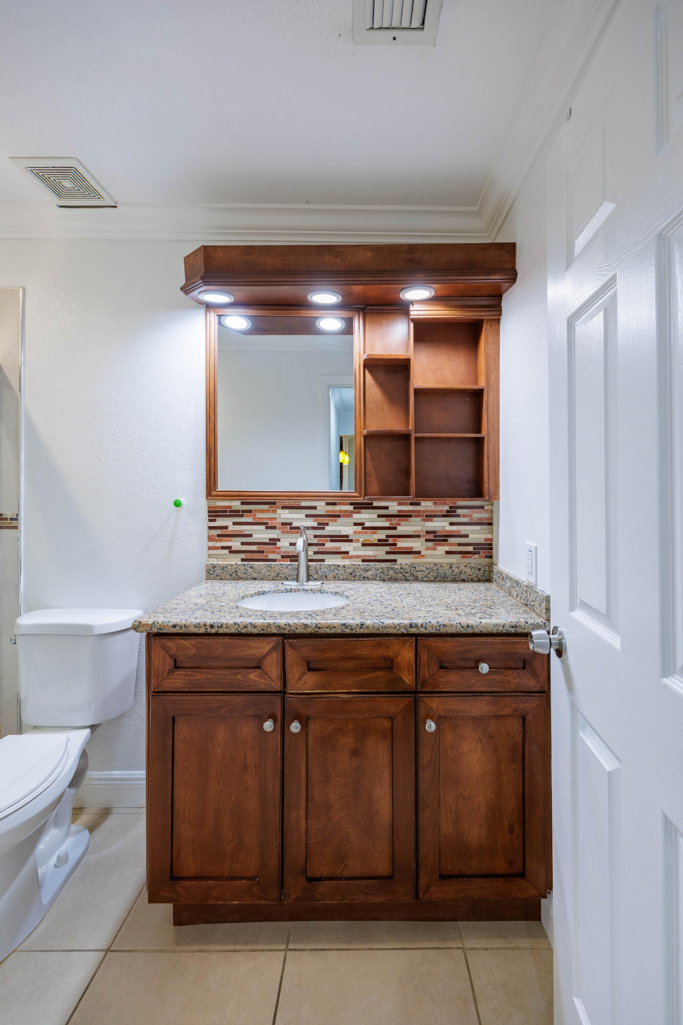 3001 Linton Boulevard, Unit 213C Delray Beach, FL 33445 - Photo 29 of 35 a bathroom with a sink and a toilet