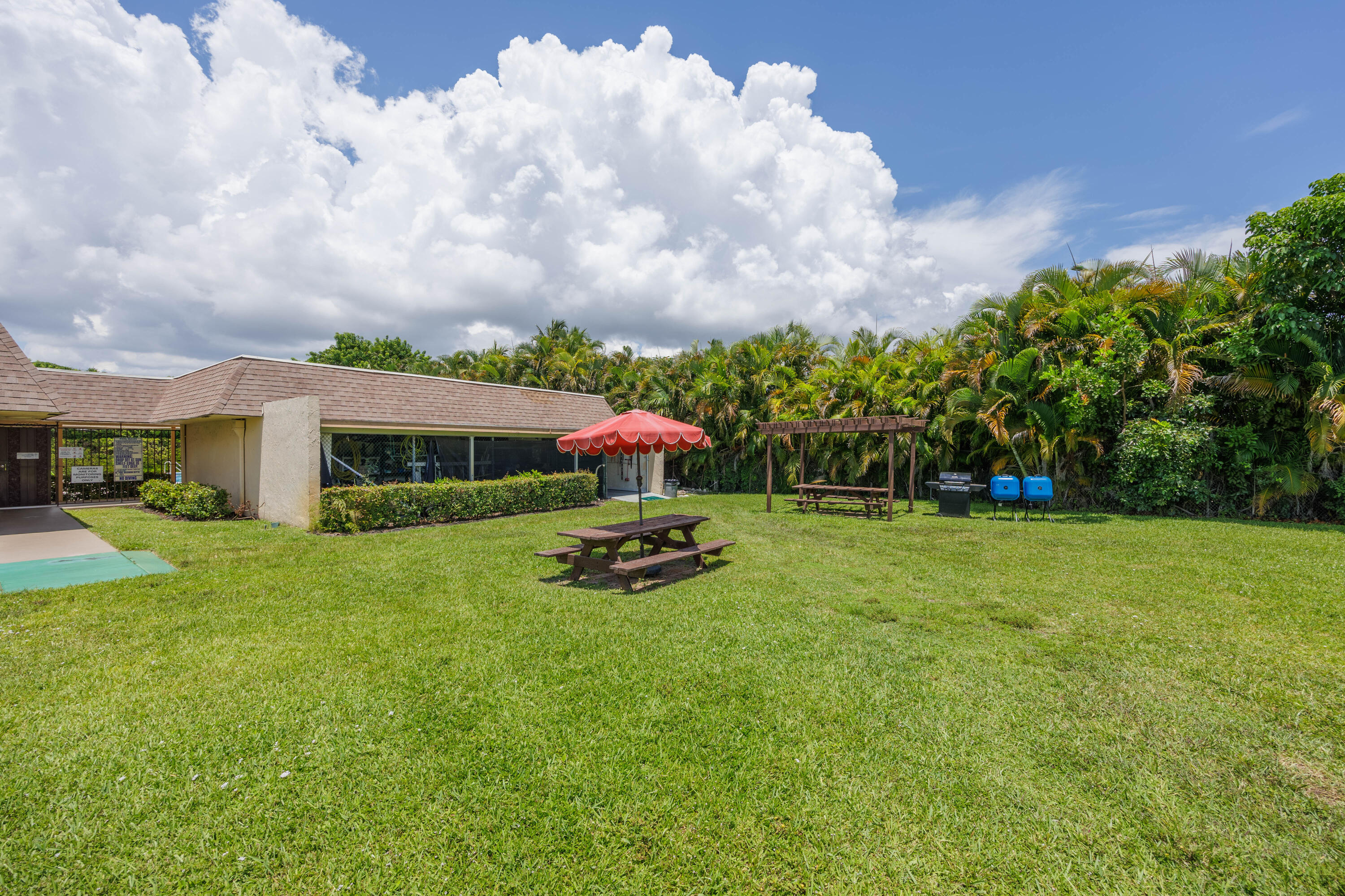 3001 Linton Boulevard, Unit 213C Delray Beach, FL 33445 - Photo 32 of 35 a front view of house with yard and trees
