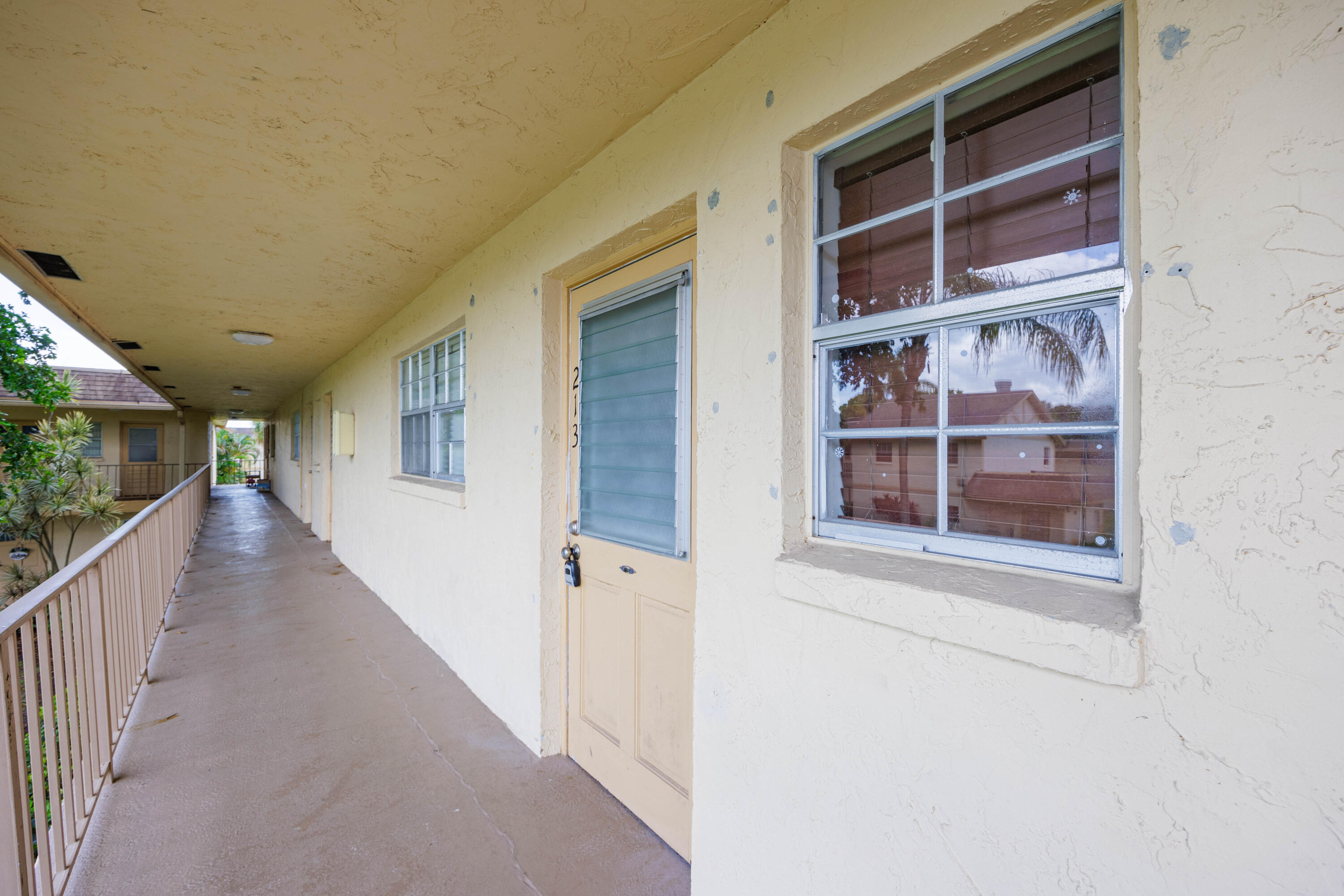 3001 Linton Boulevard, Unit 213C Delray Beach, FL 33445 - Photo 4 of 35 a view of a hallway with wooden floor and entryway