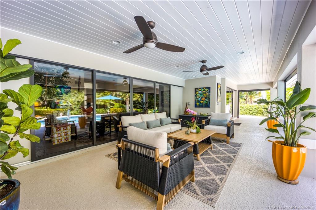 121 Hillcrest Drive Stuart, FL 34996 - Photo 14 of 65 a living room with patio furniture and a potted plant