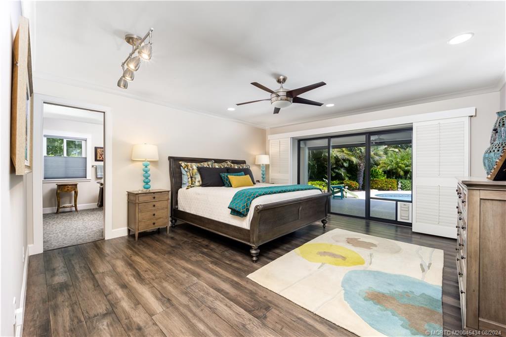 121 Hillcrest Drive Stuart, FL 34996 - Photo 27 of 65 a bedroom with a bed wooden floor and window