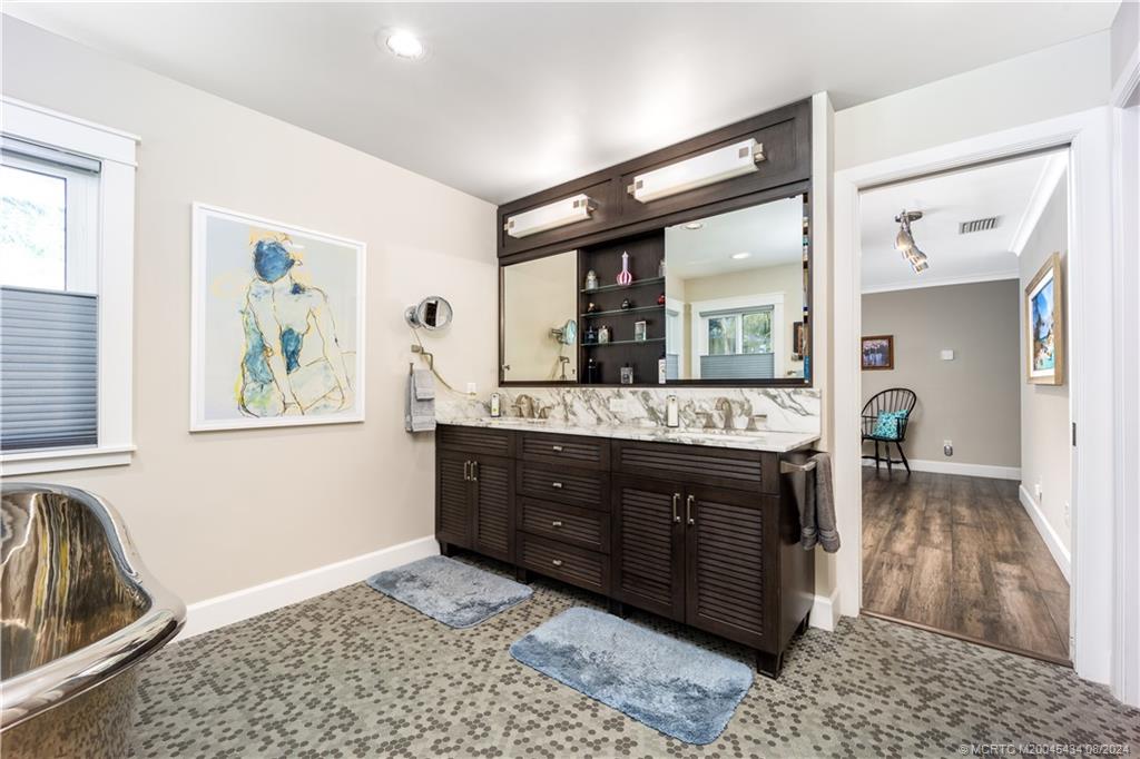 121 Hillcrest Drive Stuart, FL 34996 - Photo 30 of 65 a bathroom with a sink a vanity and a mirror