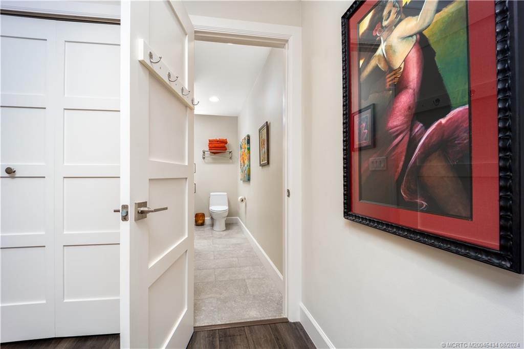121 Hillcrest Drive Stuart, FL 34996 - Photo 38 of 65 a view of a hallway with paintings on the wall and a large window