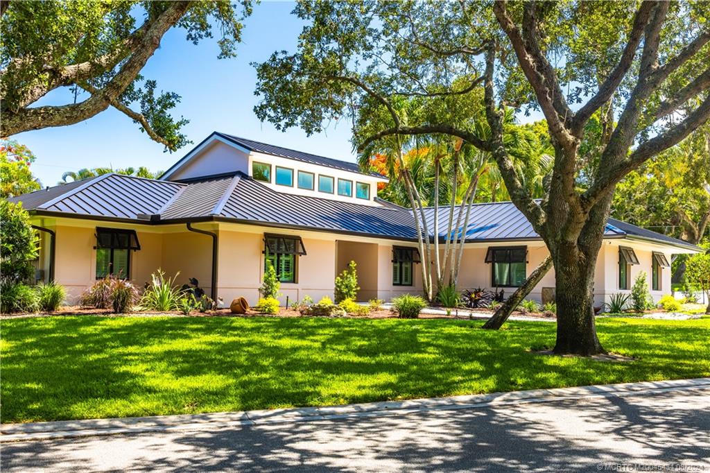 121 Hillcrest Drive Stuart, FL 34996 - Photo 62 of 65 a front view of a house with garden