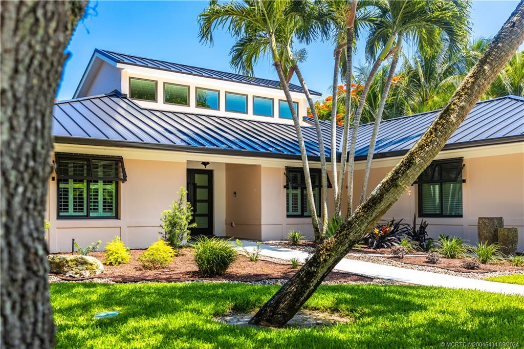 121 Hillcrest Drive Stuart, FL 34996 - Photo 64 of 65 a front view of a house with garden