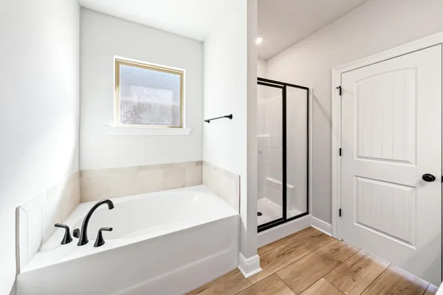 a bathroom with a bathtub and a shower